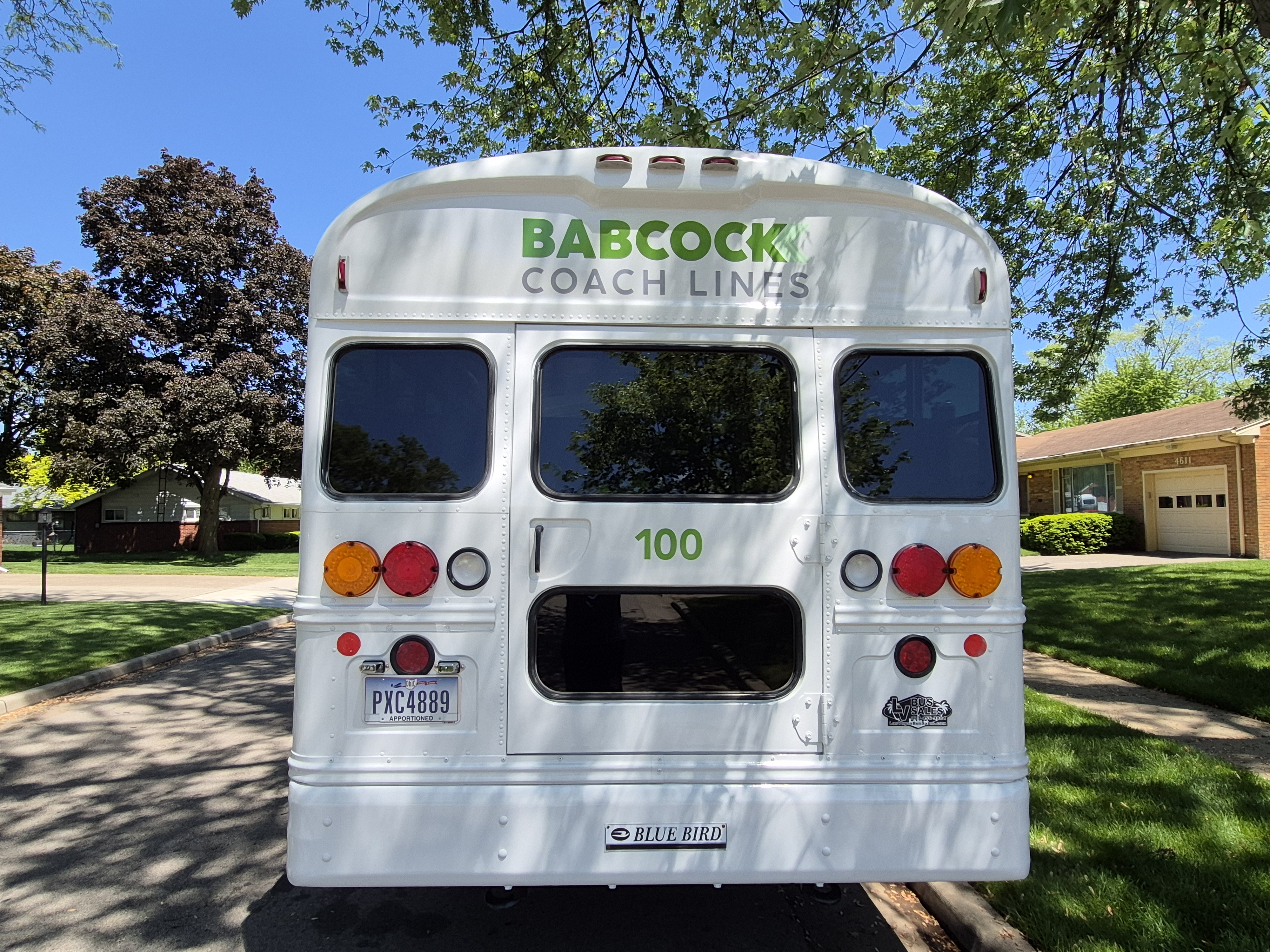Bus parked in yard rear view
